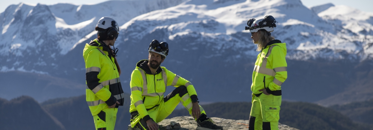 Arbeidarar i Nordic Mining med fjell i bakgrunnen