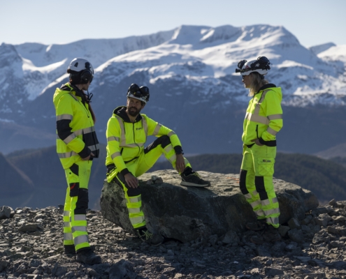 Arbeidarar i Nordic Mining med fjell i bakgrunnen